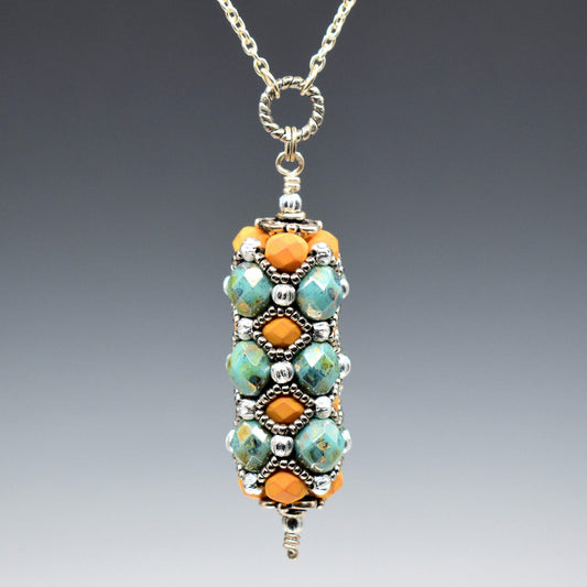 A pendant with orange and turquoise hangs from a rope textured circle and silver colored chain. The pendant is a column of bronzed turquoise faceted beads alternating with soft orange beads, all of which are overlaid with a silver seed bead netting.