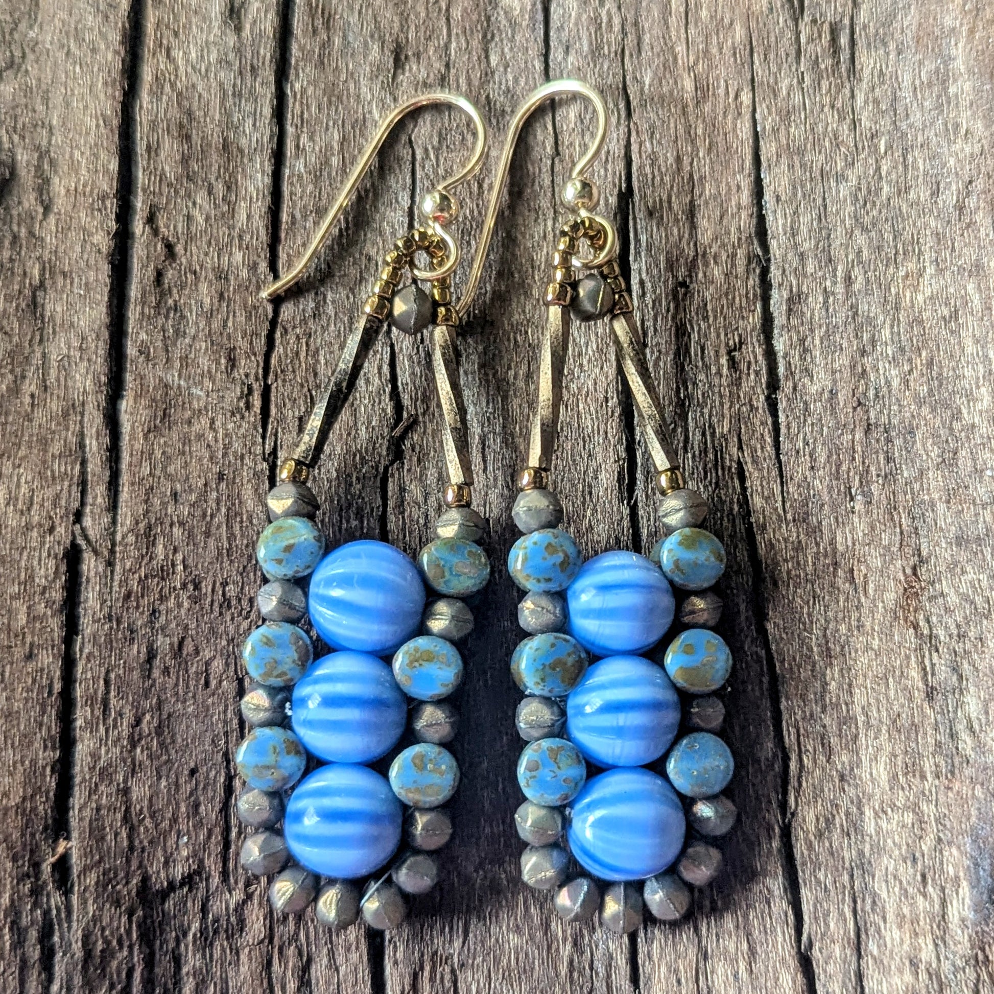 Blue beaded earrings on a wooden surface