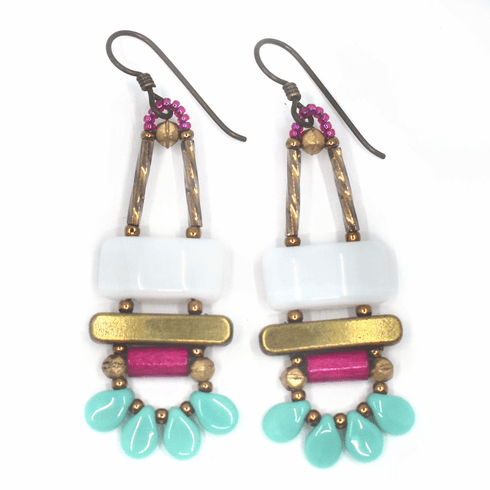 White, magenta and turquoise earrings with gold accents and dark ear wires. These earrings have a white rectangle on top of a gold bar. Belowthe bar is a magenta tube. At the bottom are four turquoise petals separated by gold seed beads.