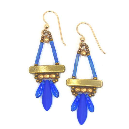 Blue and gold earrings on a white background. The earrings have a trangle shape on top, with two upright blue beads and a gold colored bar at the base. Below the bar is a row of three faceted gold beads, and below that is a row of three blue dagger shaped beads, the center one larger than the others.