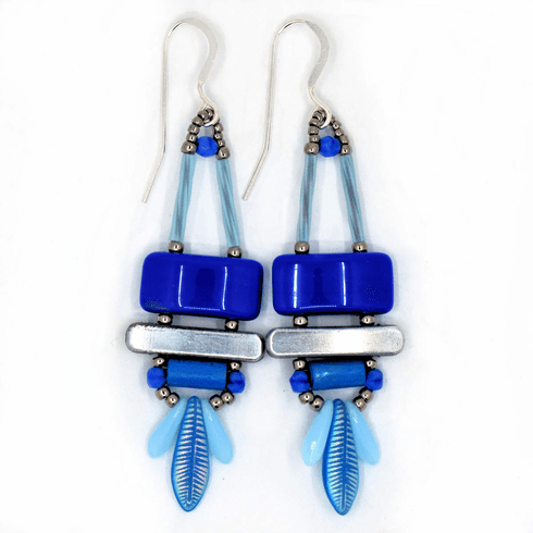 Blue and silver earrings on a white background. The earrings have a blue rectangle on top, then a silver bar. Below the bar is a medium blue tube and at the bottom is a blue dagger bead with a feather design and two smaller light blue daggers on either side.