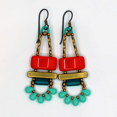 Red and turqouise earrings on a white background. The earrings have dark ear wires and gold accent. The top bead is a red rectangle, with a gold bar beneath it. Below the bar is a dark teal tube and then a swag of five small teardrops separated by gold seed beads.