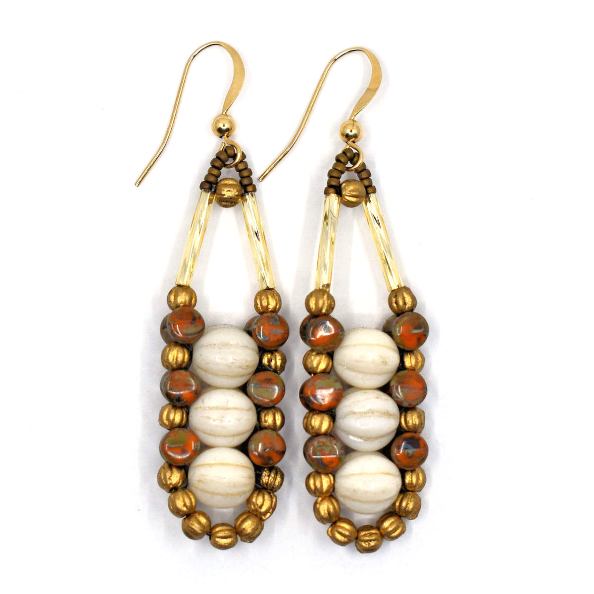 Cream, rust and gold accented earrings with gold ear wires on a white background. These earrings have three ridged cream rounds stacked vertically, held in place by an outline of speckled rusty orange and gold beads. 