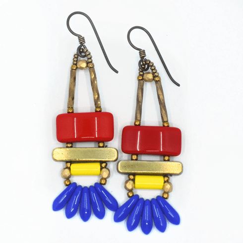 Red, yellow, and blue earrings with dark ear wires and gold accents on a white background. The earrings have a red rectangle on top, then a gold bar. Below the bar is a bright yellow tube and at the bottom is a fan of five small blue dagger beads.