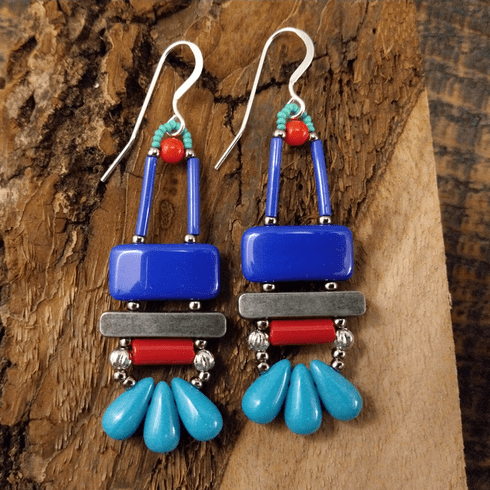 Blue, turquoise, and red earrings with silver accents and ear wires. These earrings have a blue rectangle at the top, then a silver bar. Below the bar is a red tube, and at the bottom are three medium sized turquoise drops.