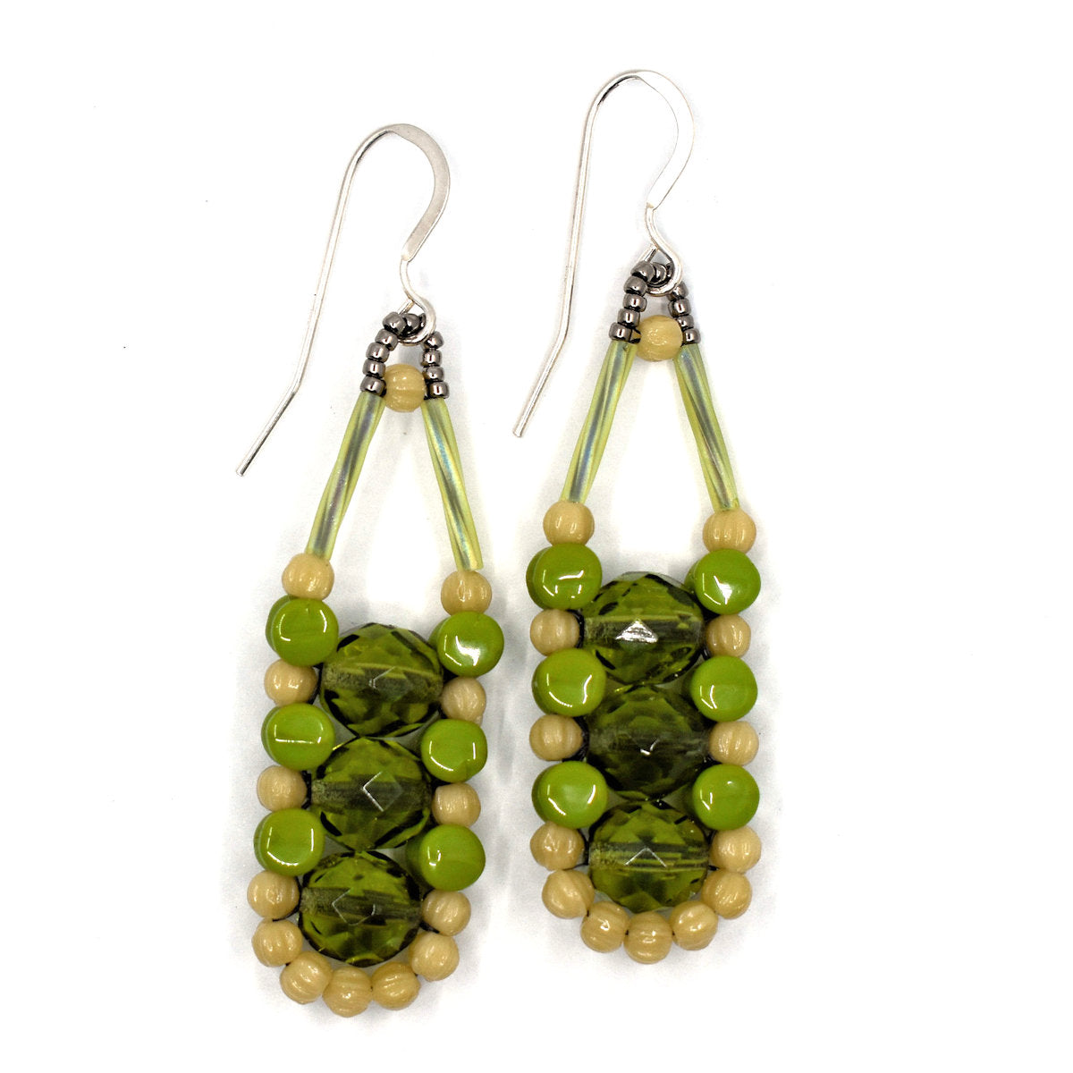 Long green earrings with dark cream and avocado, with silver accents and ear wires on a white background. There are three olive green beads stacked vertically in the center of these beads, like peas, surrounded by an outline of dark cream and avocado green beads.