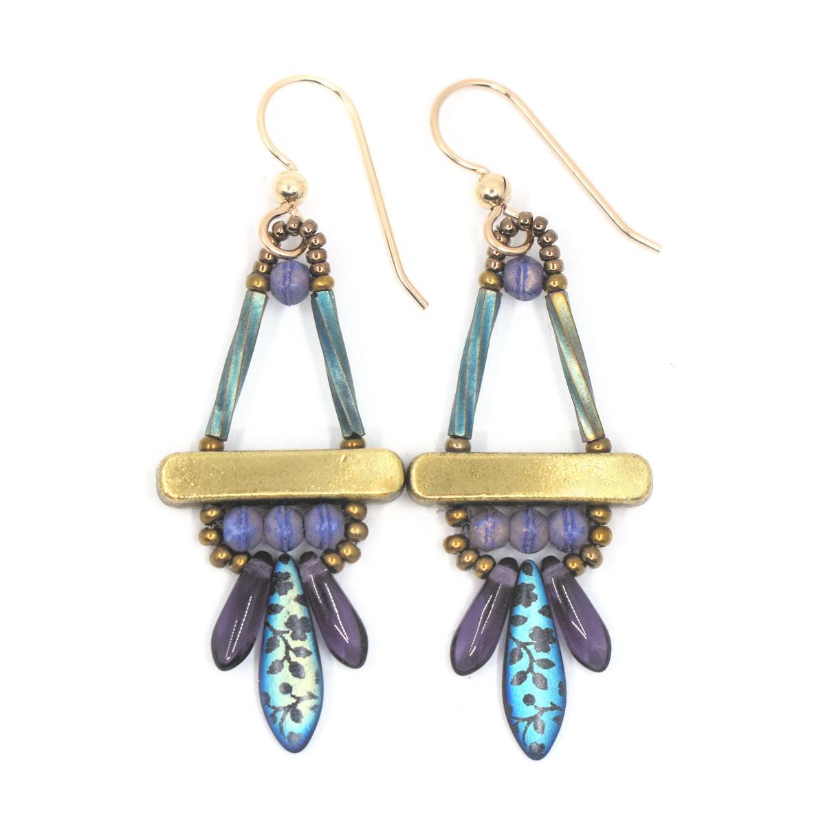 Purple and gold earrings laying on a white background. The earrings are a triangle shape on top, with a gold colored bar across the center. Below the bar there is a row of three purple beads and a lower row with one iridescent dagger bead with a flower print and a smaller clear purple dagger bead on each side of it.