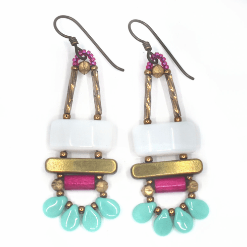 White, magenta and turquoise earrings with gold accents and dark ear wires. These earrings have a white rectangle on top of a gold bar. Belowthe bar is a magenta tube. At the bottom are four turquoise petals separated by gold seed beads. 